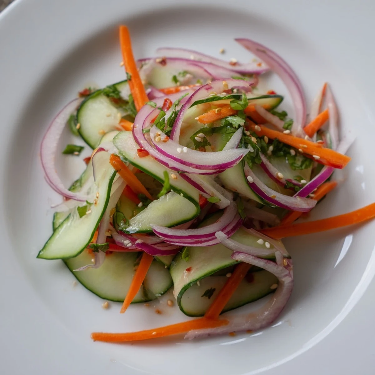 Refreshing cucumber salad remix drizzled with sesame oil and vibrant vegetables.  