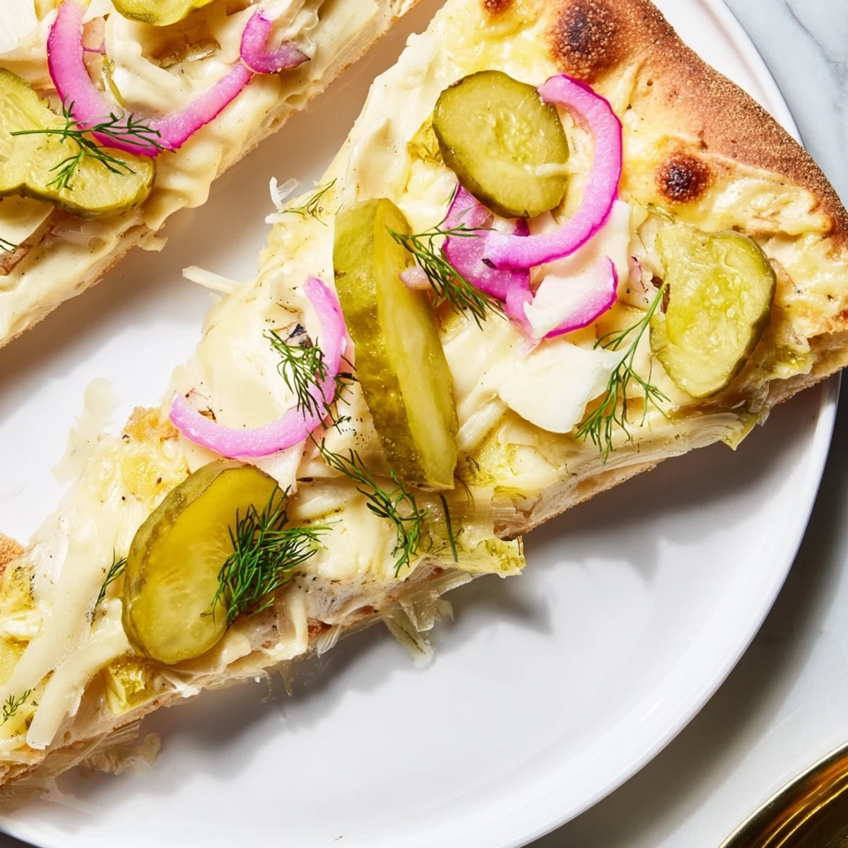 Delicious Pickle Pizza with melted mozzarella, crunchy dill pickles, and rich crème fraîche.  