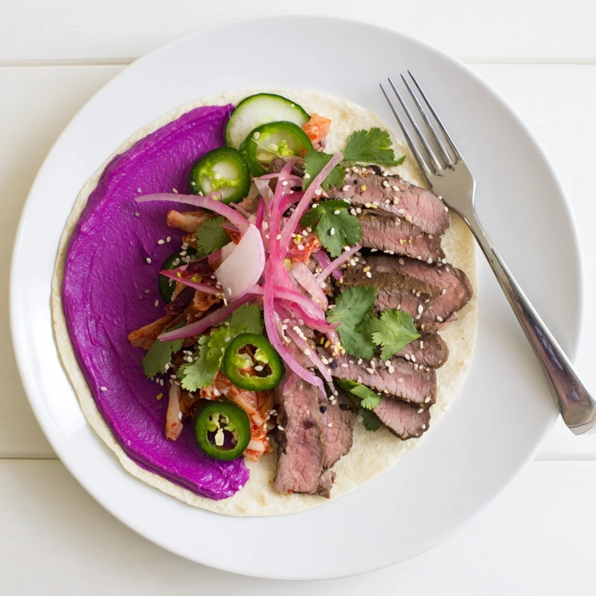 Vibrant Fusion Tacos showcase Korean flavors, topped with pickled onions and crunchy cabbage.