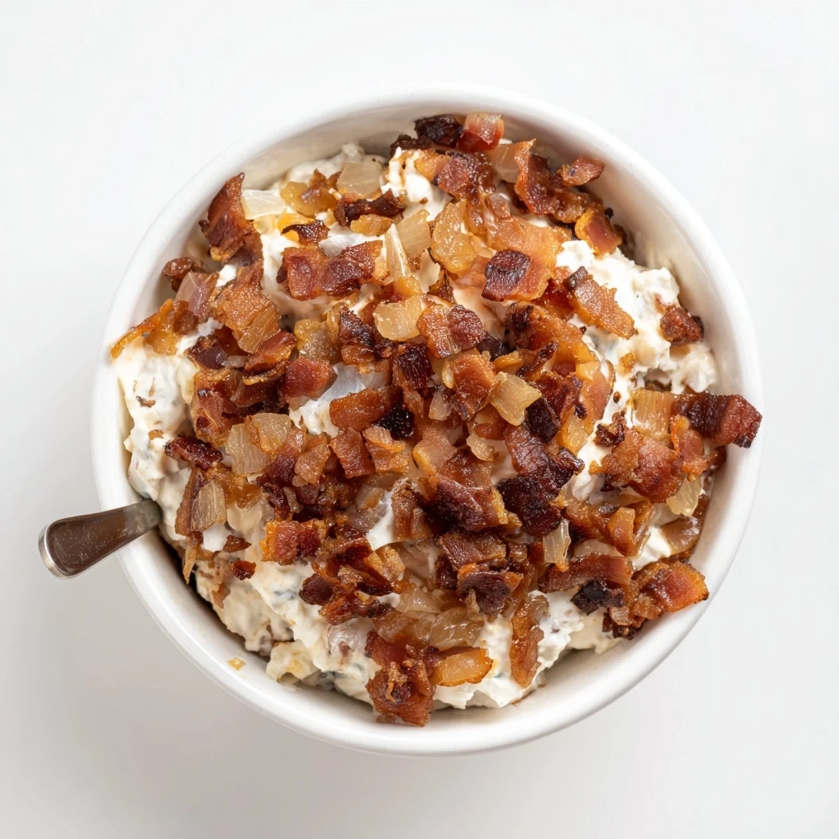 Get the party started with this rich caramelized onion and bacon dip, served with chips!