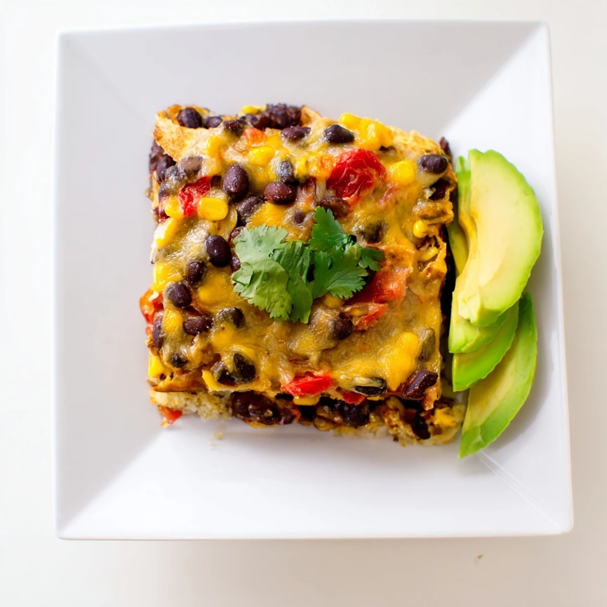 Quick Black Bean and Corn Tortilla Casserole bubbling with melted cheese, perfect for a family dinner.