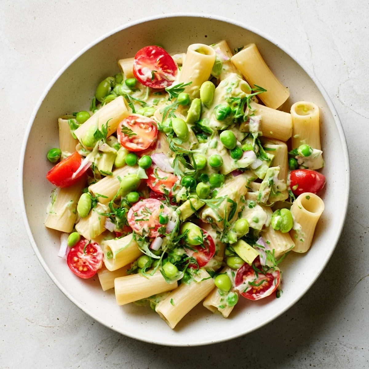 Beautiful, colorful angle of the Holiday Glow Green Goddess Protein Pasta Salad—a nutritious and flavorful meal.
