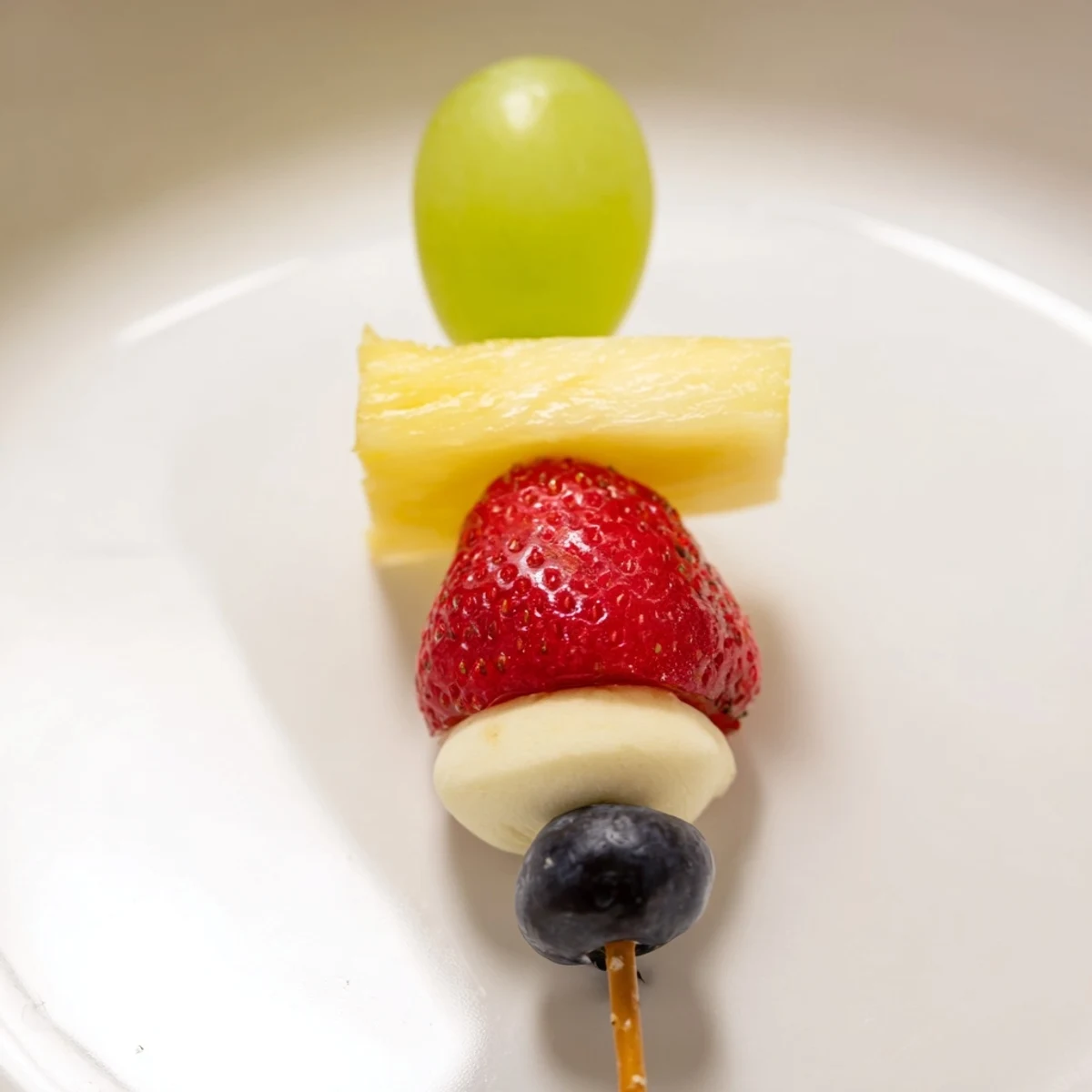 Sweet, colorful Christmas Light Fruit Skewers offer a healthy and festive appetizer for any winter party.