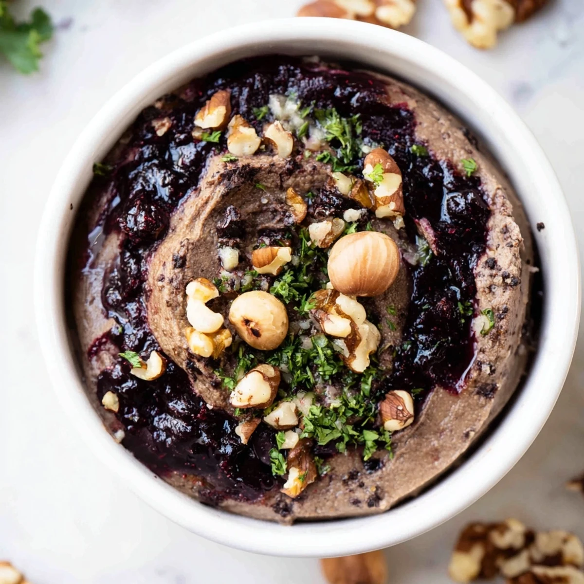 A layered The Velvet Underground appetizer with smooth pâté, vibrant jams, and crunchy nuts.