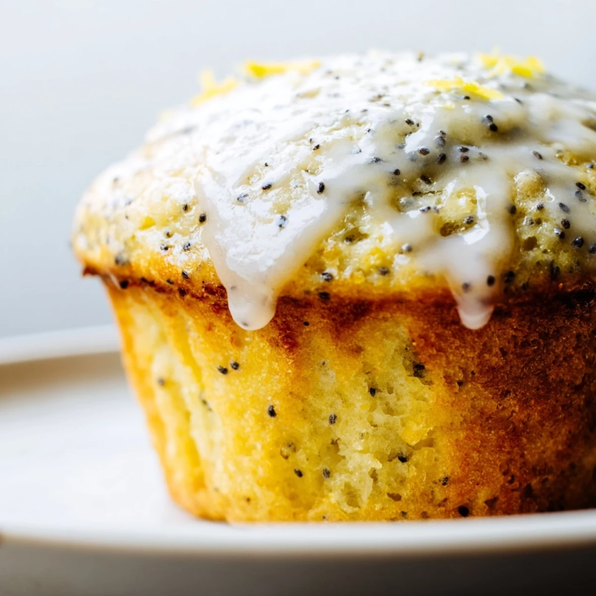 Golden-topped lemon poppy seed muffins, fluffy and delicious, ready for a delightful breakfast spread.
