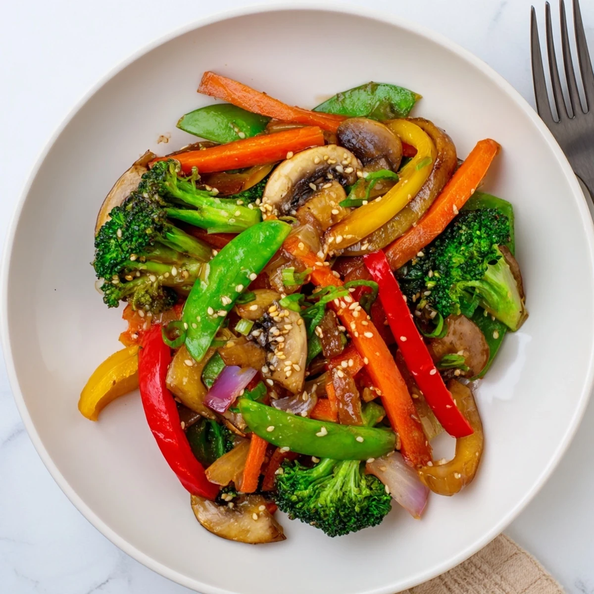 Fresh ginger stir-fried vegetables on a rustic plate, showing tender mushrooms, bright carrots, and snap peas tossed in a glossy ginger-soy sauce.
