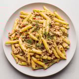 A close-up of a flavorful bowl of Turkish Pasta with Ground Turkey, creamy yogurt and tender pasta.