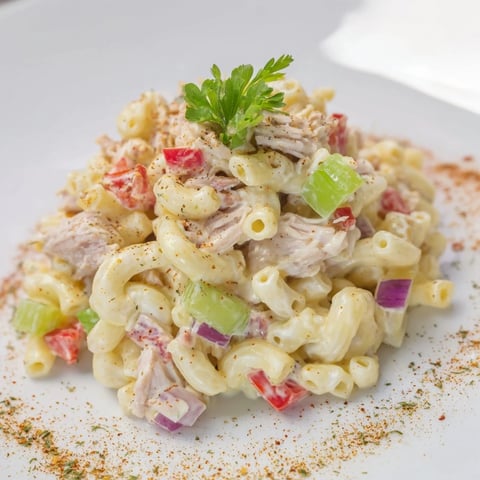 A bowl of creamy chilled Chicken Macaroni Holiday Salad, ready for a potluck, full of color.