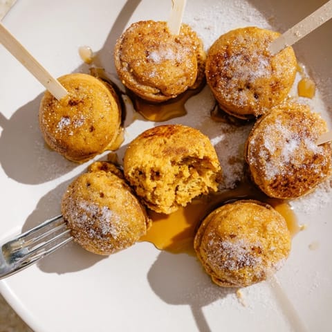 Bite-sized pancake pops infused with pumpkin and spices, ideal for casual snacking.  
