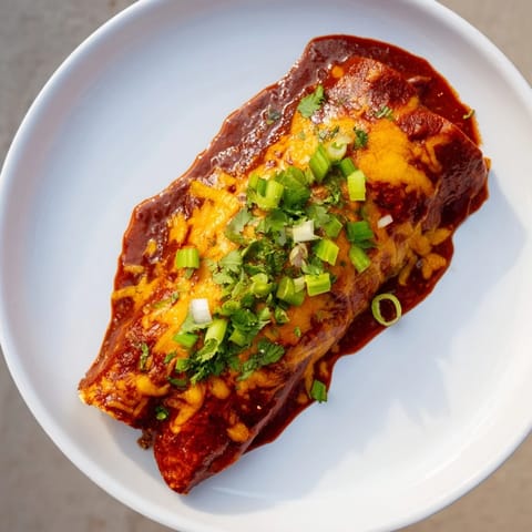 Golden-baked cheesy bean enchiladas with a rich, savory aroma and layers of melted cheddar.
