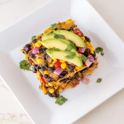 A hearty Quick Black Bean and Corn Tortilla Casserole brimming with layers of beans, corn, and warm salsa.