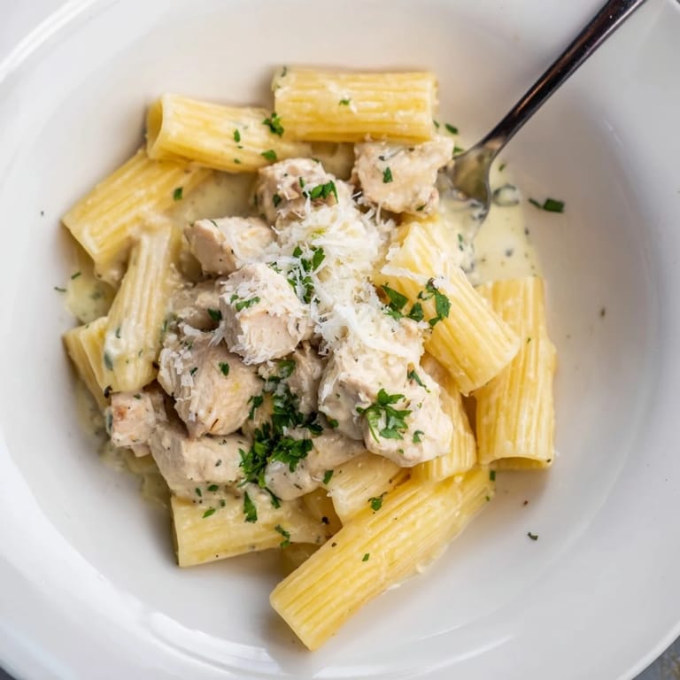 Golden chicken pieces mixed with rigatoni in rich Garlic Parmesan sauce.