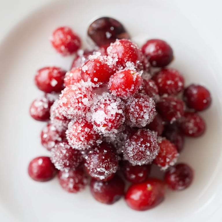 Bright red 5-Minute Express Candied Cranberries, coated in glistening sugar, ready for holiday garnishing.