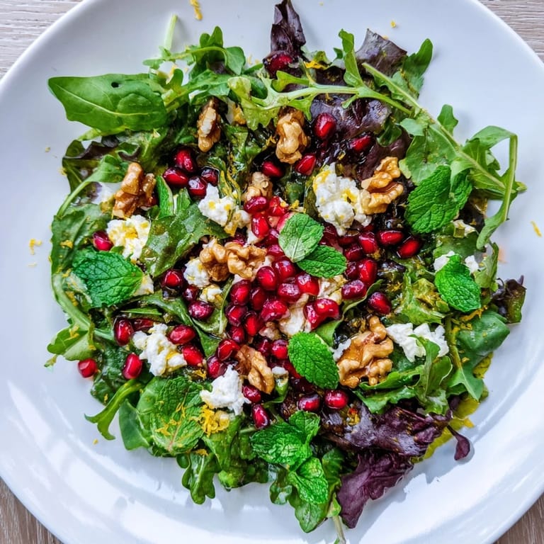 A visually appealing Pomegranate Feta Wreath Salad, ready to serve for a festive, fresh meal.