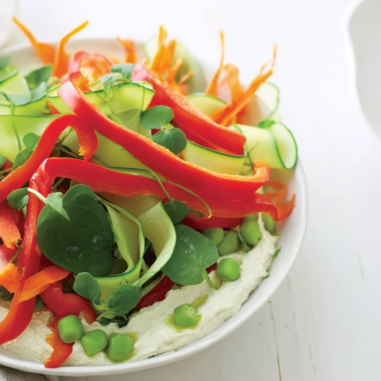 Close-up photo of a delicious Snowflake Hummus & Roasted Veggie Wrap, stuffed with roasted vegetables.