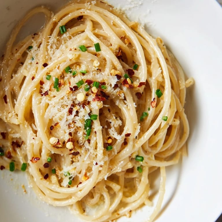 Close-up of creamy Miso Butter Pasta: a visually appealing blend of pasta, cheese, and flavorful sauce.