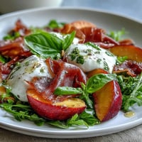 Summery Peach Burrata Prosciutto Salad with creamy burrata and sweet peaches.